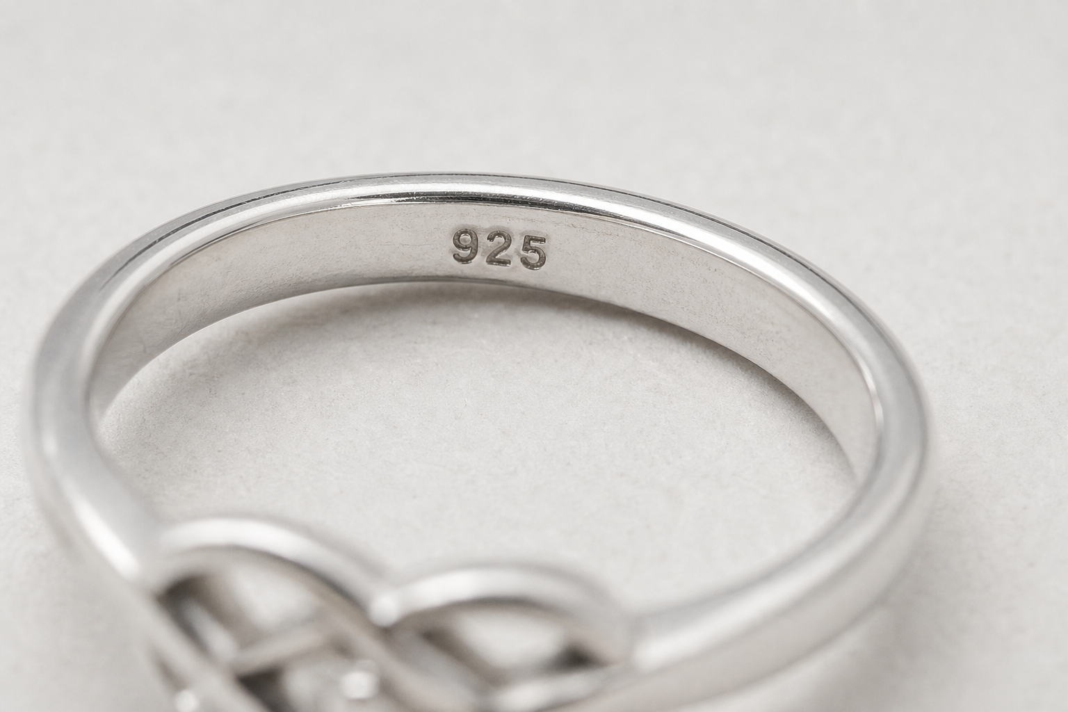 Close-up of a sterling silver ring with a visible 925 stamp inside the band