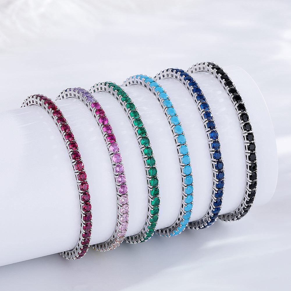 Mixed color-stone 3mm tennis bracelets made in 925 silver on a white jewelry display roll