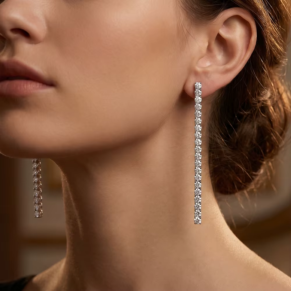 Model wearing 925 silver drop earrings with clear stones