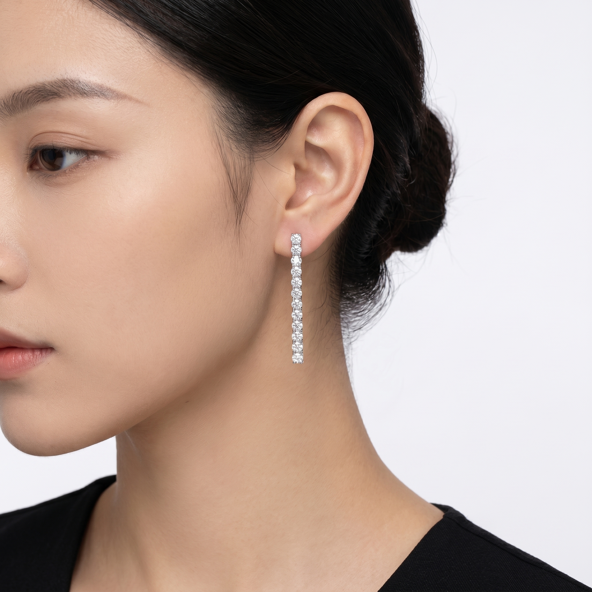 Model wearing long 925 silver drop earrings